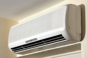 Wall-mounted ductless mini split AC unit installed in a corner, representing mini split installation.