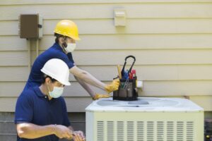 technicians-repairing-AC-cabinet