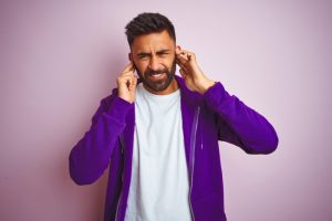 person-covering-their-ears